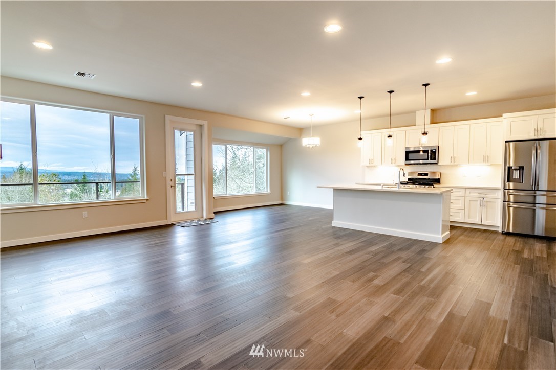 1710 Doe Run Road Sequim, WA 98382 - Photo 8 of 34 an empty room with wooden floor and windows