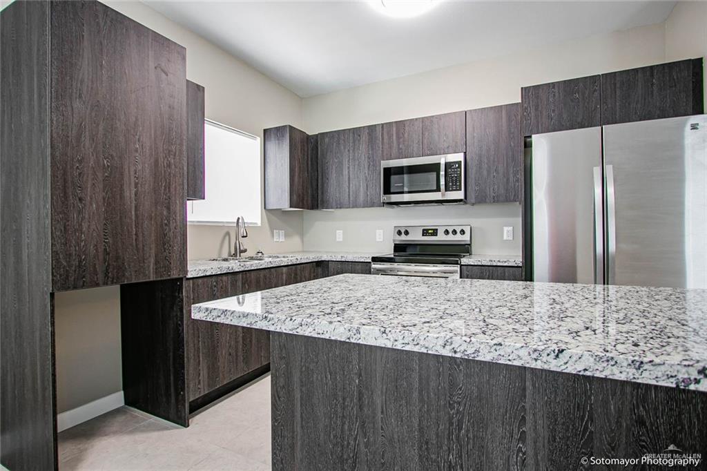 3408 Golden Nugget, Unit 1 Edinburg, TX 78541 - Photo 4 of 8 a kitchen with a refrigerator sink and microwave