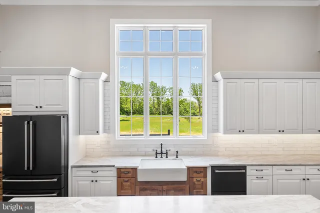 a kitchen with cabinets and stainless steel appliances