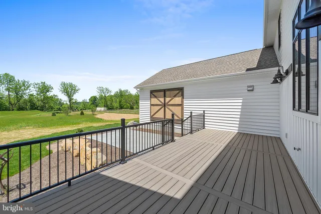 a view of a wooden deck with a yard
