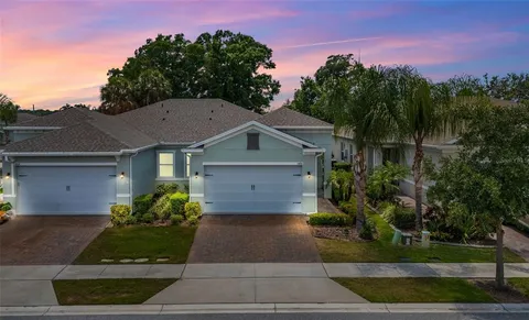 a front view of a house with a yard and trees