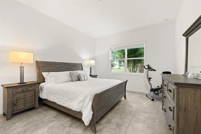 a spacious bathroom with a granite countertop sink a mirror and a shower
