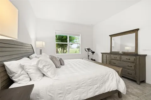 a en suite bathroom with a granite countertop sink and a mirror