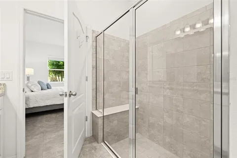 a bedroom with a bed and a night stand