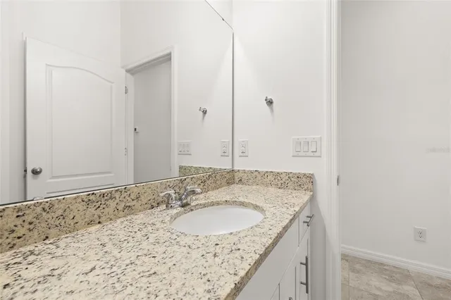 a view of a backyard with table and chairs and potted plants