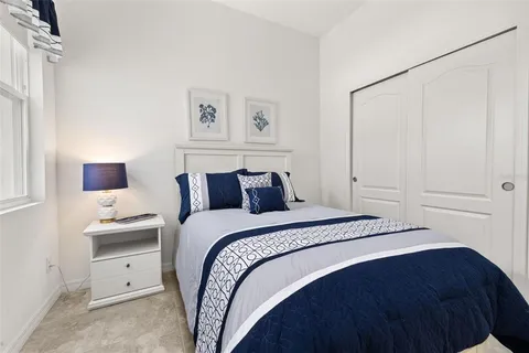 a view of a house with a yard and potted plants