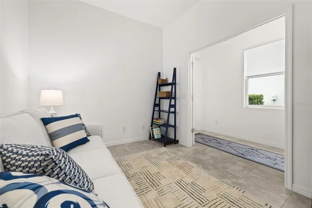 an aerial view of a city with lots of residential buildings and mountain view in back