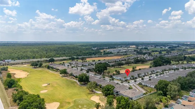 a living room with furniture floor to ceiling window and potted plants
