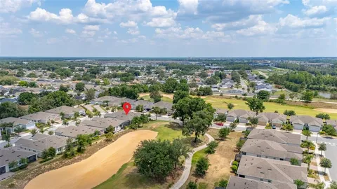 an aerial view of a house with a yard and lake view