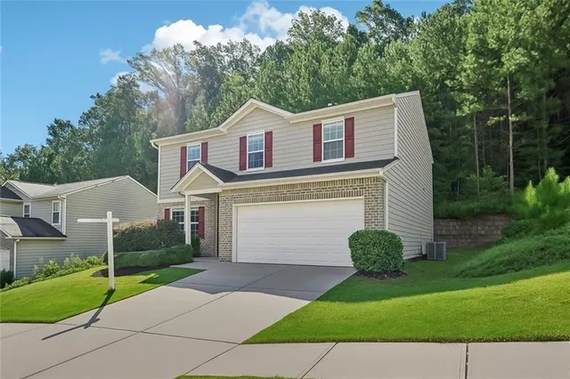 a front view of a house with a yard and garage