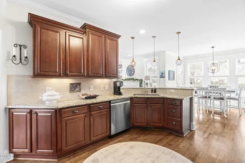 a large kitchen with stainless steel appliances granite countertop a sink a stove and cabinets
