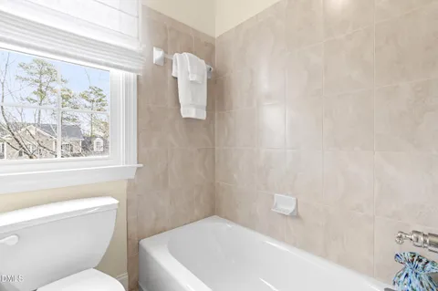 a bedroom with a bed couch and a window