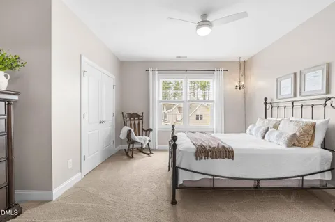 a bedroom with a bed and a chair