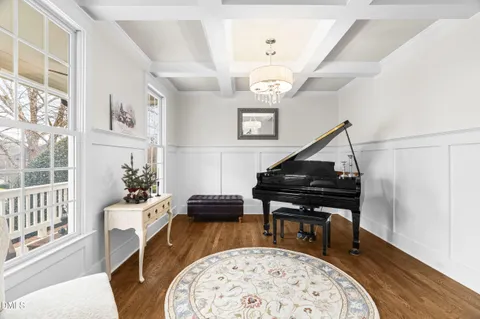 a living room with furniture and a piano