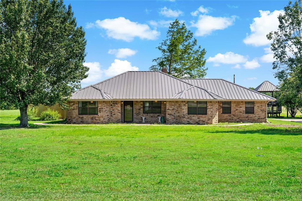 4395 Farm Road 2820 Brookston, TX 75421 - Photo 1 of 33 a front view of a house with a garden