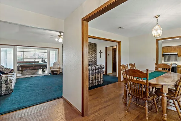 a kitchen with a sink cabinets and dining table