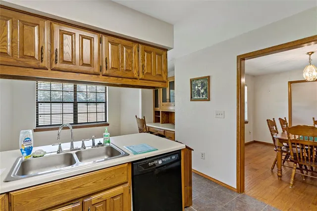 a dining room with stainless steel appliances kitchen island granite countertop furniture and a window