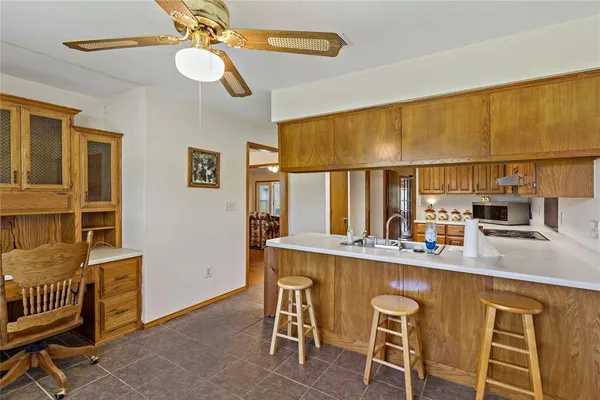 a kitchen with granite countertop a sink cabinets stainless steel appliances and a window