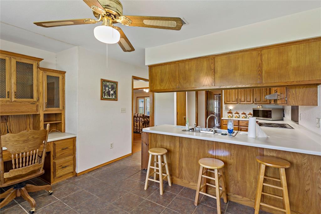 4395 Farm Road 2820 Brookston, TX 75421 - Photo 16 of 33 a dining room with stainless steel appliances kitchen island granite countertop furniture and a window