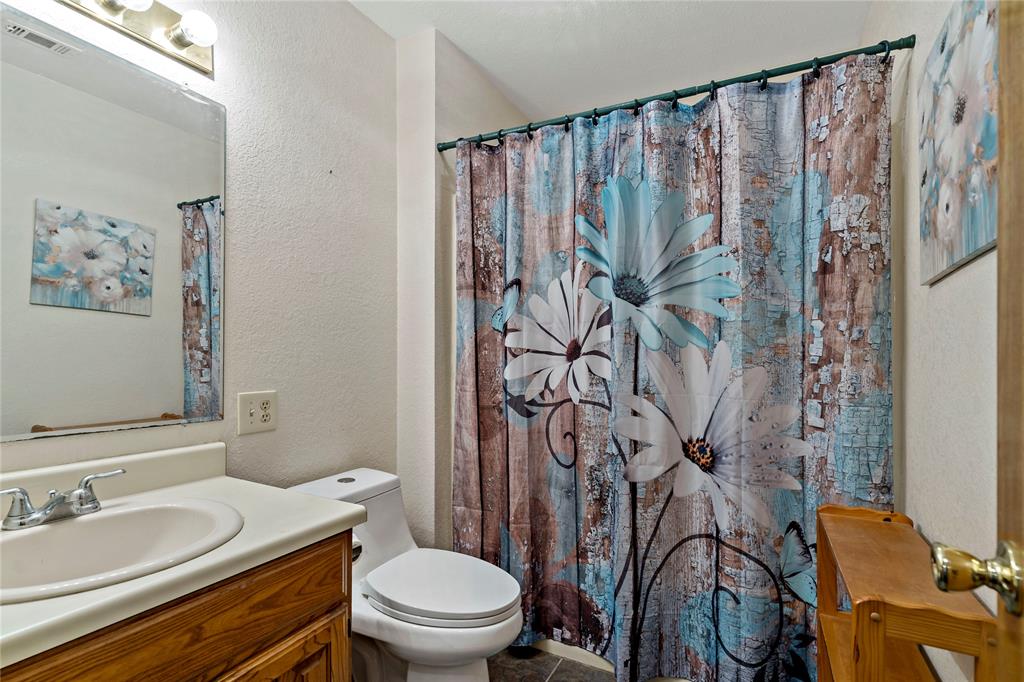 4395 Farm Road 2820 Brookston, TX 75421 - Photo 20 of 33 a bathroom with a granite countertop sink and a mirror
