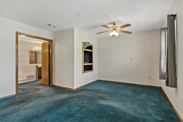 a bathroom with a tub a sink and a mirror