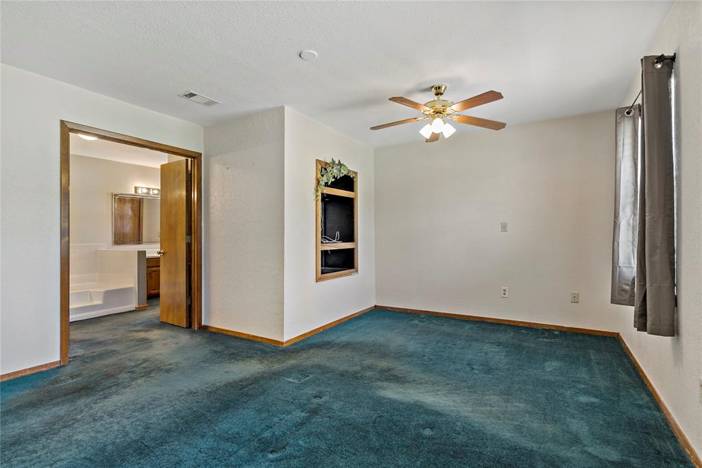4395 Farm Road 2820 Brookston, TX 75421 - Photo 23 of 33 an empty room with closet and a chandelier fan