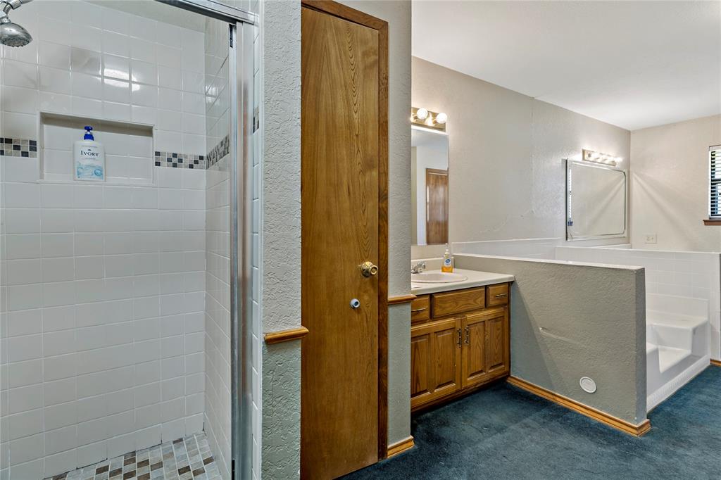 4395 Farm Road 2820 Brookston, TX 75421 - Photo 26 of 33 a bathroom with a sink a mirror and a shower