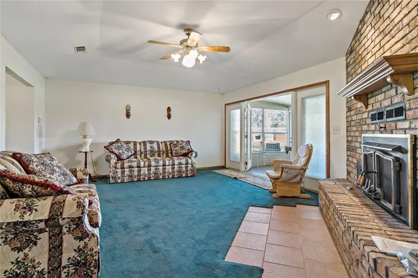 a room with lots of trees and couches