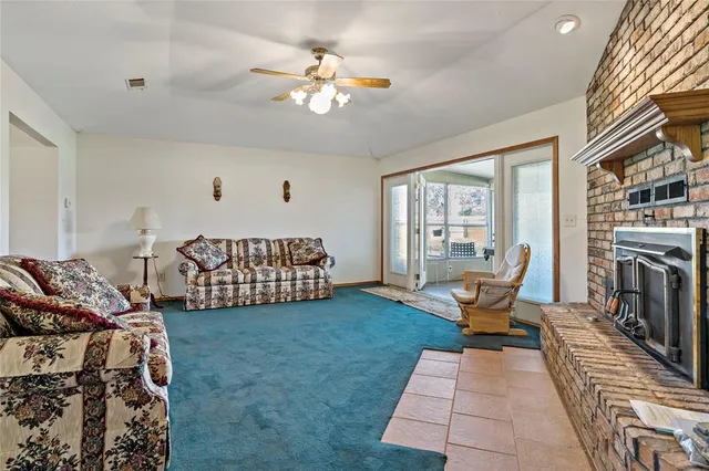 a room with lots of trees and couches