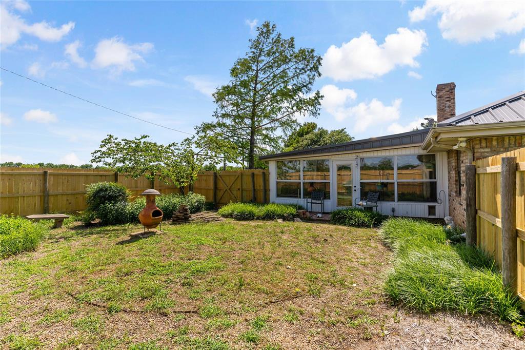 4395 Farm Road 2820 Brookston, TX 75421 - Photo 32 of 33 a view of a house with backyard sitting area and garden