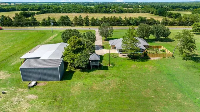 an aerial view of a house with yard swimming pool and outdoor seating