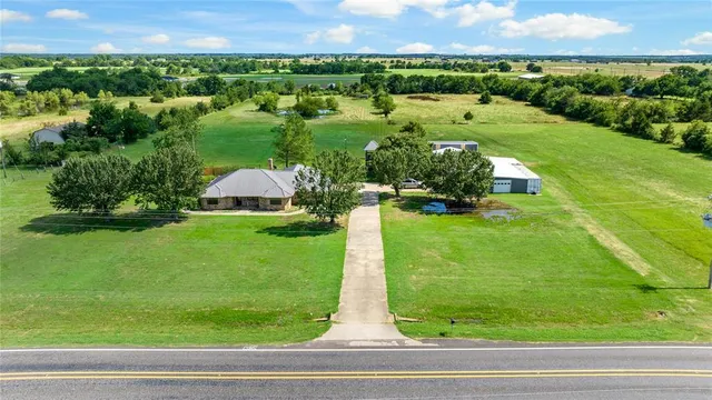 a aerial view of a house with a yard