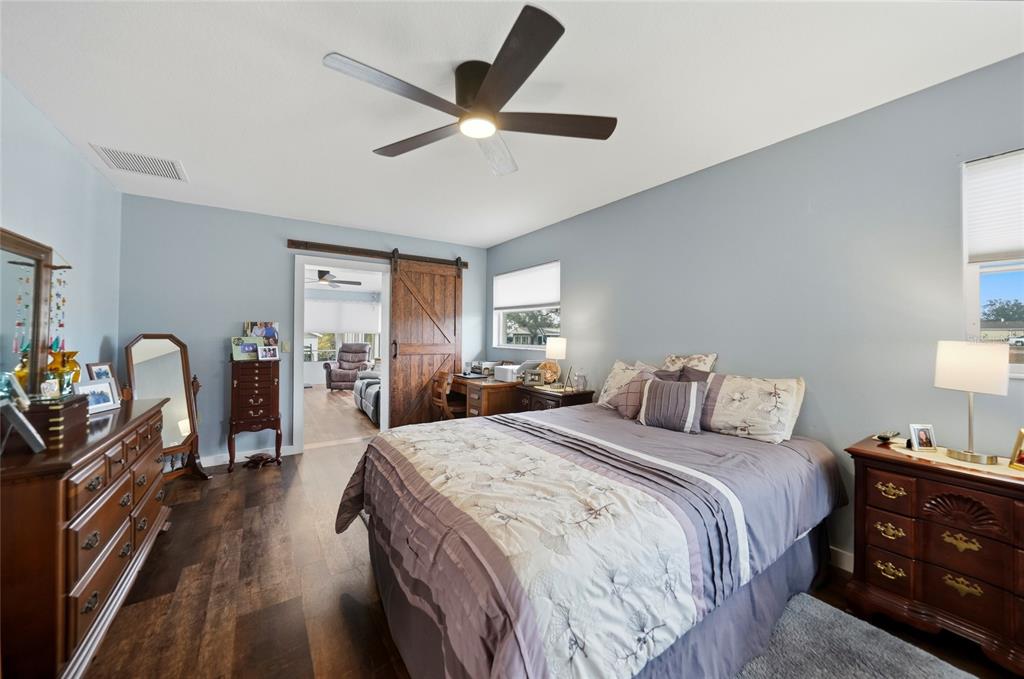 405 Ridgecrest Drive Punta Gorda, FL 33982 - Photo 11 of 30 a spacious bedroom with a bed a dresser and wooden floor