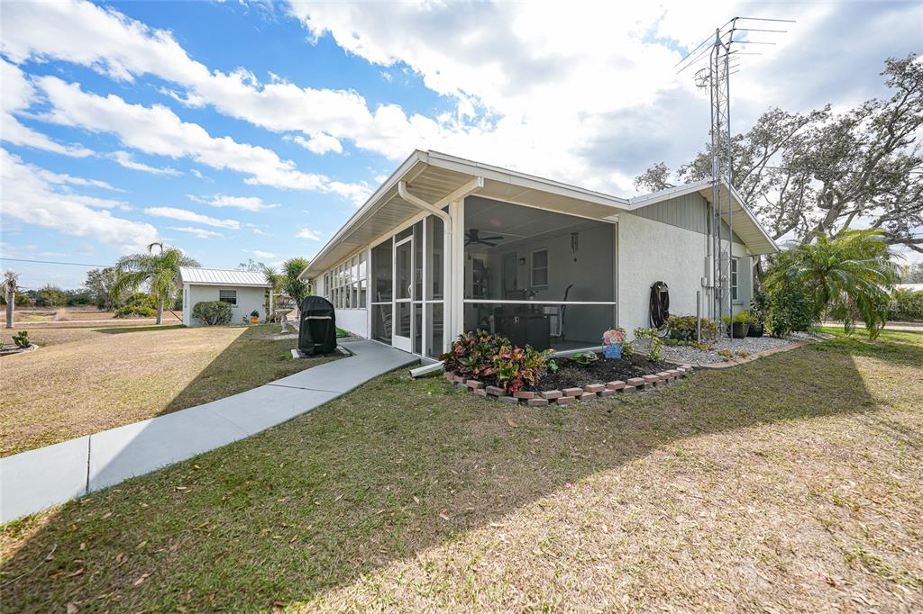 405 Ridgecrest Drive Punta Gorda, FL 33982 - Photo 21 of 30 a view of a house with backyard and trees in the background