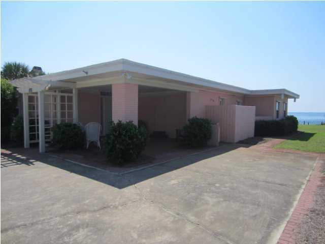 570 Blue Mountain Road Santa Rosa Beach, FL 32459 - Photo 3 of 24 a view of a house with potted plants and a garage