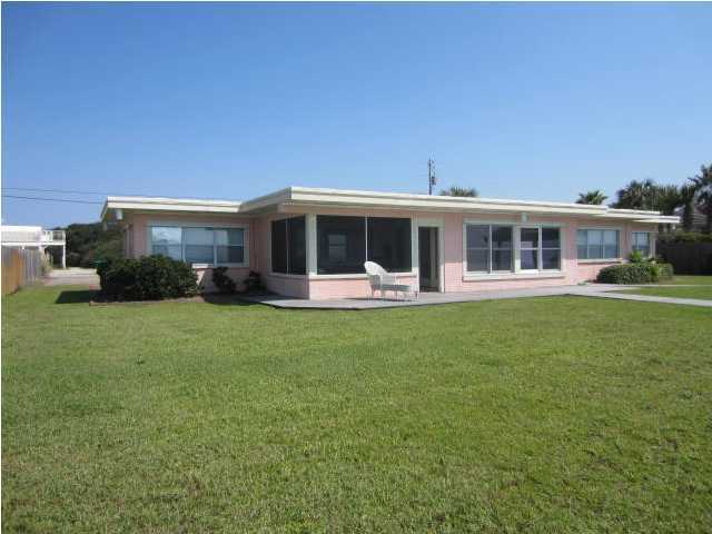 570 Blue Mountain Road Santa Rosa Beach, FL 32459 - Photo 4 of 24 a view of a house with a backyard patio and a garden