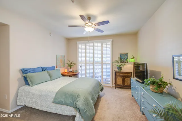 a bedroom with a bed and ceiling fan