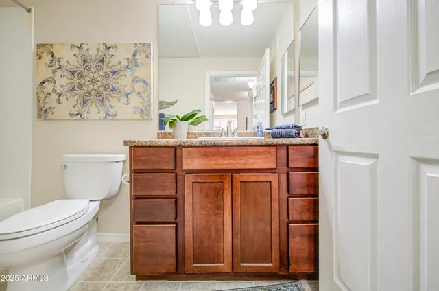 a bathroom with a toilet a sink and a mirror