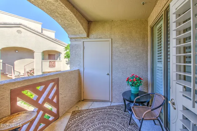 a living room with furniture and flowers