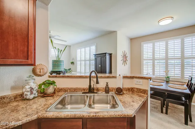 a kitchen with granite countertop a sink and a granite counter tops with a window