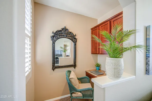 a living room with furniture and a potted plant