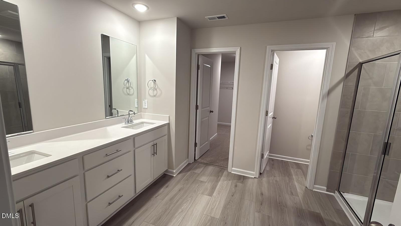 710 White Birch Lane Angier, NC 27501 - Photo 18 of 31 a spacious bathroom with a double vanity sink and a mirror