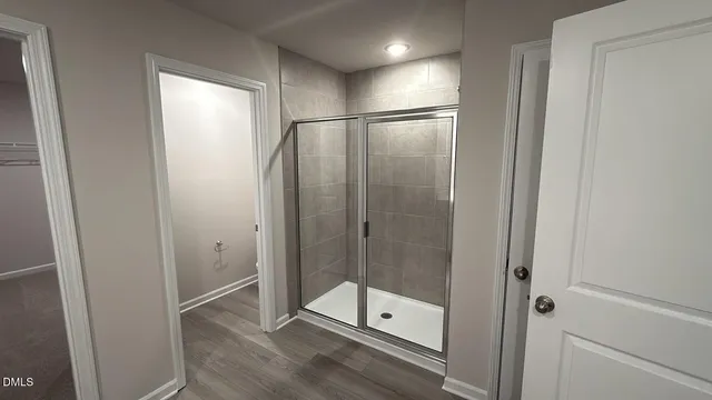 a bathroom with a glass shower door