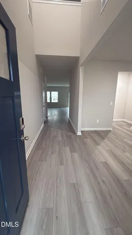 a view of a hallway view with wooden floor and staircase