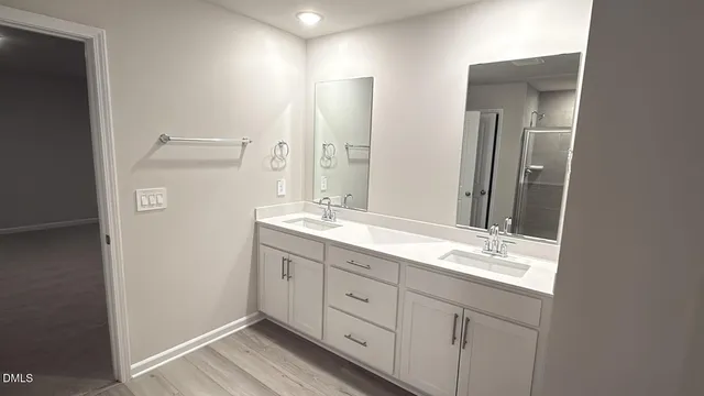 a bathroom with a double vanity sink and mirror