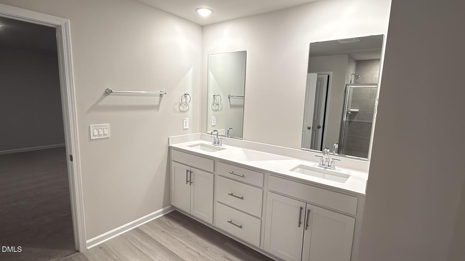 710 White Birch Lane Angier, NC 27501 - Photo 21 of 31 a bathroom with a double vanity sink and mirror