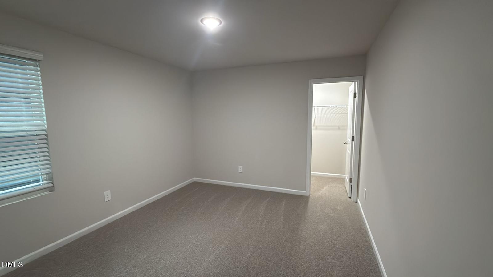 710 White Birch Lane Angier, NC 27501 - Photo 30 of 31 an empty room with wooden floor and windows