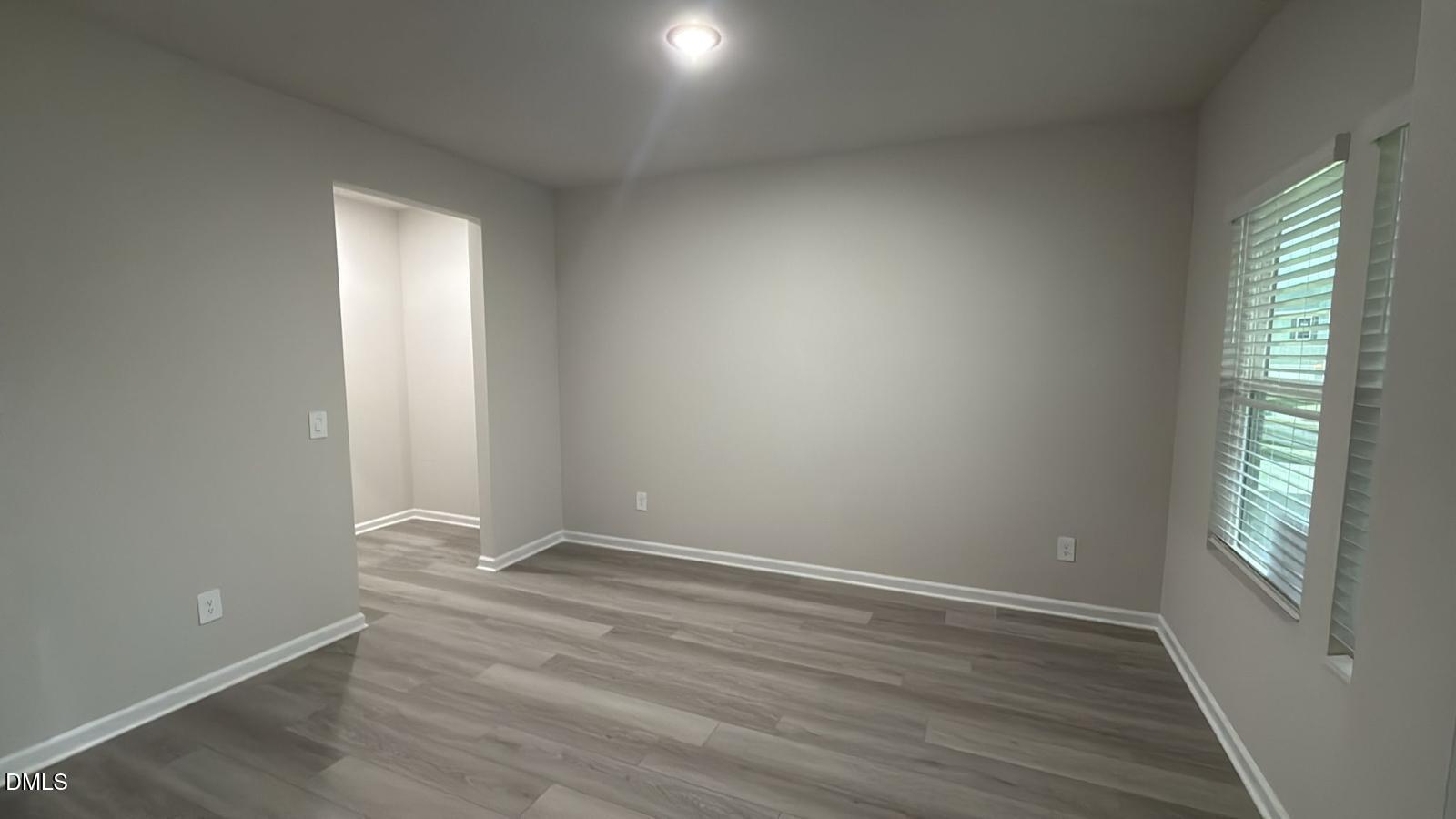 710 White Birch Lane Angier, NC 27501 - Photo 5 of 31 an empty room with wooden floor and windows