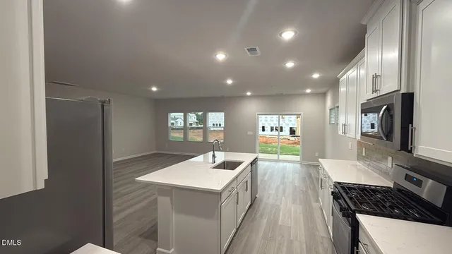 a kitchen with sink and refrigerator