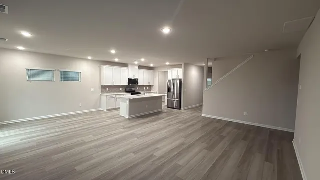 a view of a kitchen with a sink and a refrigerator